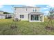 Two-story home with covered patio and backyard at 1446 Maddie Berry Ln, Kissimmee, FL 34744