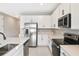 Bright kitchen features stainless steel appliances and white cabinets at 1446 Maddie Berry Ln, Kissimmee, FL 34744