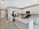 Modern kitchen features stainless steel appliances and an island with white cabinets at 1446 Maddie Berry Ln, Kissimmee, FL 34744