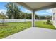 Covered patio overlooking a fenced backyard with grassy lawn at 1446 Maddie Berry Ln, Kissimmee, FL 34744