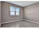 Simple bedroom with gray walls, tile floors, and a window with blinds at 830 Ballantyne Dr, Lake Wales, FL 33898