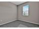 Bright bedroom with gray walls, gray carpeting, and a window with blinds at 830 Ballantyne Dr, Lake Wales, FL 33898