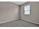 Bright bedroom with gray walls, gray carpeting, and a window with blinds at 830 Ballantyne Dr, Lake Wales, FL 33898