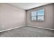 Spacious bedroom featuring gray walls, carpet, and a window with blinds at 830 Ballantyne Dr, Lake Wales, FL 33898