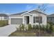 One-story house with gray siding, two-car garage, and landscaped front yard at 830 Ballantyne Dr, Lake Wales, FL 33898