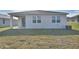 Rear view of house showcasing a covered patio and lawn at 830 Ballantyne Dr, Lake Wales, FL 33898