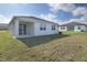 House exterior showcasing backyard, patio, and neighboring house at 830 Ballantyne Dr, Lake Wales, FL 33898