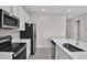 Modern kitchen with white cabinets, stainless steel appliances, and large island at 830 Ballantyne Dr, Lake Wales, FL 33898
