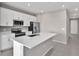 Modern kitchen with white cabinets, stainless steel appliances, and large island at 830 Ballantyne Dr, Lake Wales, FL 33898