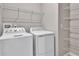 Laundry room with washer, dryer, and ample shelving at 830 Ballantyne Dr, Lake Wales, FL 33898