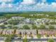Aerial view showing townhome location near shops at 9532 Silver Buttonwood St, Orlando, FL 32832