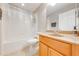 Bathroom with tub, toilet, and wood vanity at 9532 Silver Buttonwood St, Orlando, FL 32832