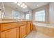 Double vanity bathroom with a soaking tub, and tile flooring at 9532 Silver Buttonwood St, Orlando, FL 32832