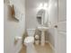 Small half bathroom with pedestal sink and toilet at 9532 Silver Buttonwood St, Orlando, FL 32832