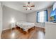 Bedroom with wood floors, ceiling fan, and ample closet space at 9532 Silver Buttonwood St, Orlando, FL 32832