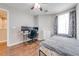 Bright bedroom with wood floors, a workspace, and ample natural light at 9532 Silver Buttonwood St, Orlando, FL 32832