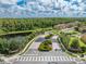 Aerial view of community entrance with landscaping and pond at 9532 Silver Buttonwood St, Orlando, FL 32832