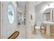 Foyer with tile floor, half bathroom, and front door at 9532 Silver Buttonwood St, Orlando, FL 32832