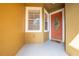 Inviting orange front door with a clover-shaped glass insert at 9532 Silver Buttonwood St, Orlando, FL 32832