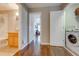 Hallway showing bathroom and laundry area at 9532 Silver Buttonwood St, Orlando, FL 32832