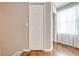 Clean hallway with a linen closet and wood flooring at 9532 Silver Buttonwood St, Orlando, FL 32832