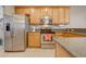 Kitchen boasts stainless steel appliances and wood cabinets at 9532 Silver Buttonwood St, Orlando, FL 32832
