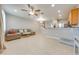 Open concept living room and kitchen with neutral decor at 9532 Silver Buttonwood St, Orlando, FL 32832
