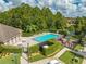 Community pool with lounge chairs and playground area at 9532 Silver Buttonwood St, Orlando, FL 32832