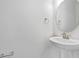 Small bathroom with pedestal sink, mirror, and towel rack at 1416 Maddie Berry Ln, Kissimmee, FL 34744