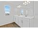 Double vanity bathroom with a large mirror and tile floor at 1416 Maddie Berry Ln, Kissimmee, FL 34744