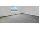 Bright bedroom featuring new carpeting and a large window at 1416 Maddie Berry Ln, Kissimmee, FL 34744