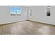 Spacious bedroom with large windows and wood-look tile floors at 1416 Maddie Berry Ln, Kissimmee, FL 34744