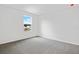 Simple bedroom with a large window and grey carpeting at 1416 Maddie Berry Ln, Kissimmee, FL 34744
