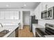 Bright kitchen features stainless steel appliances and white cabinetry at 1416 Maddie Berry Ln, Kissimmee, FL 34744