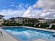 Inviting community pool with lounge chairs at 2060 Cypress Bay Blvd, Kissimmee, FL 34743