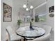 Bright breakfast nook with a round table, chairs, and large windows offering views at 2891 Swoop Cir, Kissimmee, FL 34741
