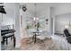 Cozy breakfast nook with a round table, four chairs, and natural light from the windows at 2891 Swoop Cir, Kissimmee, FL 34741