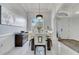 Bright dining room with white and wood accents, stylish light fixture and large window at 2891 Swoop Cir, Kissimmee, FL 34741
