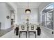 Elegant dining room featuring a glass table, white chairs, modern chandelier, and marble floors at 2891 Swoop Cir, Kissimmee, FL 34741