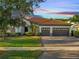 Beautiful single-story home with a tile roof, three-car garage, and well-manicured landscaping at 2891 Swoop Cir, Kissimmee, FL 34741