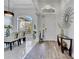 Welcoming foyer with wood-look tile flooring, large windows, and a view into the dining room at 2891 Swoop Cir, Kissimmee, FL 34741