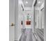 Hallway with mirrored closet doors, leading to the bathroom with double sinks at 2891 Swoop Cir, Kissimmee, FL 34741
