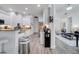 Well-lit kitchen featuring white cabinets, stainless steel appliances, and hardwood floors at 2891 Swoop Cir, Kissimmee, FL 34741