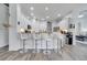 Bright kitchen with white cabinetry, granite counters, stainless steel appliances, and bar seating at 2891 Swoop Cir, Kissimmee, FL 34741
