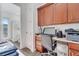 Features a wood desk with upper cabinets and a view of the attached bathroom and outdoor access at 2891 Swoop Cir, Kissimmee, FL 34741