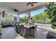 Inviting outdoor patio with comfortable seating, dining area, and view of the lush backyard at 2891 Swoop Cir, Kissimmee, FL 34741