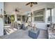 Inviting covered patio with outdoor dining area, ceiling fans, and a mounted TV at 2891 Swoop Cir, Kissimmee, FL 34741