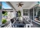 Inviting outdoor patio features stylish wicker furniture, overhead fan, and easy access to the home's interior at 2891 Swoop Cir, Kissimmee, FL 34741