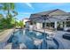 Relaxing backyard oasis with a private pool, comfortable seating, umbrella, and lush landscaping for outdoor enjoyment at 2891 Swoop Cir, Kissimmee, FL 34741