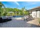 Relaxing pool area with outdoor seating, a barbecue, and a view of the lush landscape at 2891 Swoop Cir, Kissimmee, FL 34741